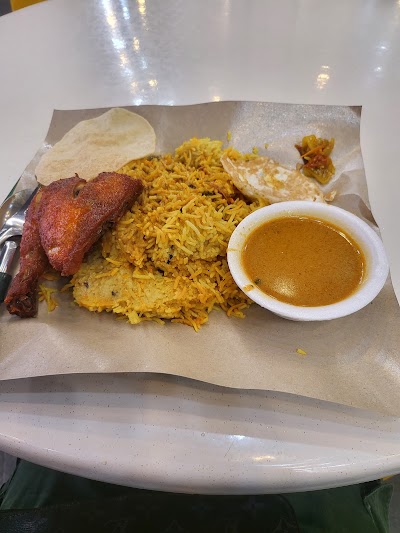 Al-Jalal by Habib's Rojak dish featuring tandoori chicken, yellow rice, naan bread, and curry sauce served on parchment paper — Items: Chicken Biryani · Yellow Rice · Tandoori Chicken · Naan Bread · Curry Sauce · Papadum