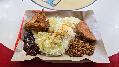 Nasi Lemak plate featuring fried chicken, coconut rice, fried egg, sambal, peanuts, and meat patty from JustEat Nasi Lemak Economic Bee Hoon. — Items: Fried Chicken · Nasi Lemak (Coconut Rice) · Fried Egg · Sambal (Chili Paste) · Peanuts · Meat Patty