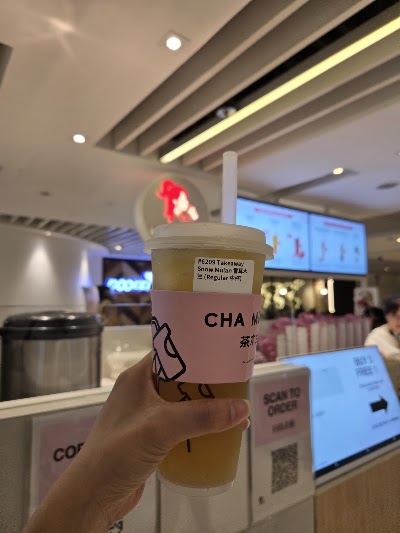CHA MULAN bubble tea drink - Takeaway Snow Mutan Regular size in pink branded cup with straw in modern tea shop interior — Items: Snow Mutan 雪玉木兰 Regular 中杯