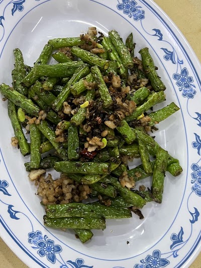 Okra with Minced Meat stir-fry dish served on a blue and white patterned plate at San Gu Cuisine restaurant. — Items: Okra with Minced Meat