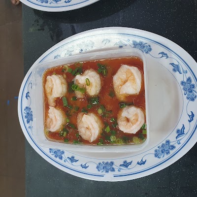 Shrimp in Chili Oil from San Gu Cuisine - six plump shrimp in spicy red chili oil sauce garnished with green onions, served in a white bowl with blue floral pattern. — Items: Shrimp in Chili Oil