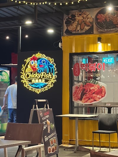 Chickyfish Korean restaurant storefront featuring neon sign, menu items including Army Stew, Beef Bulgogi Rice, and Korean food displayed in window with sliced meat presentation. — Items: Army Stew · Beef Bulgogi Rice · Korean Food · Kelli Beer $5