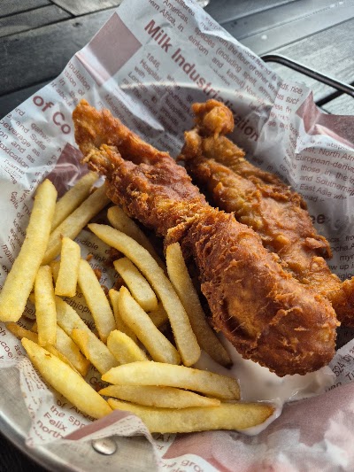 Chickyfish fried chicken with crispy golden coating served with french fries on printed wrapper — Items: Fried Chicken · French Fries