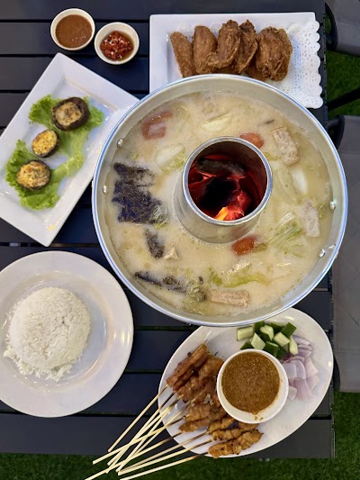 Tom Yum Hot Pot spread with steamed rice, spring rolls, fried eggplant, satay skewers, and various dipping sauces from 1036 Fusion — Items: Tom Yum Hot Pot · Steamed Rice · Spring Rolls · Fried Eggplant · Satay Skewers · Peanut Dipping Sauce · Chili Sauce · Sweet and Sour Sauce · Cucumber and Onion Salad