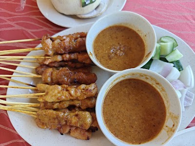 Southeast Asian satay skewers with peanut sauce, cucumber, and steamed bun from 1036 Fusion restaurant. — Items: Satay Skewers · Peanut Sauce · Cucumber Slices · Steamed Bun