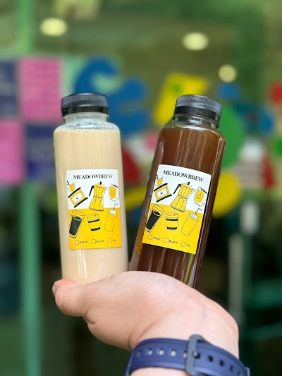 Meadowbrew bottled beverages featuring white and black tea options in clear and dark brown bottles with yellow labels. — Items: White Tea · Black Tea