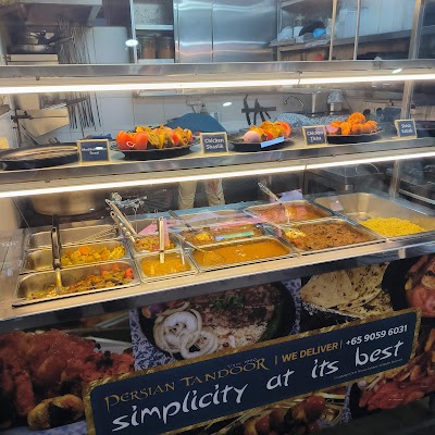 Persian Tandoor restaurant display with Mediterranean Roast, Chicken Shastik, Chicken Tikka, and Shish Kebab in heated counter, plus multiple curry and rice dishes in serving trays. — Items: Mediterranean Roast · Chicken Shastik · Chicken Tikka · Shish Kebab · Tandoori chicken · Various curries and rice dishes