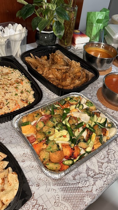 Srisun Prata catering spread featuring fried chicken, fried rice, vegetable stir-fry with tofu, curry sauce, sambal sauce, and prata roti. — Items: Fried Chicken · Fried Rice · Vegetable Stir-Fry with Tofu · Curry Sauce · Sambal/Chili Sauce · Prata/Roti