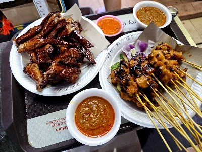 M BBQ Wings & Satay platter featuring roasted meat, BBQ wings, satay skewers with peanut sauce and chili dipping sauces — Items: BBQ Wings · Satay Skewers · Roasted Meat (likely duck or chicken) · Peanut Sauce · Chili Sauce · Spicy Dipping Sauce