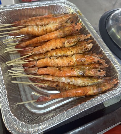 Grilled prawns skewers and satay from M BBQ Wings & Satay (Soon Lee Heng), golden-brown charred seafood on wooden skewers in aluminum tray. — Items: Grilled Prawns Skewers · Satay