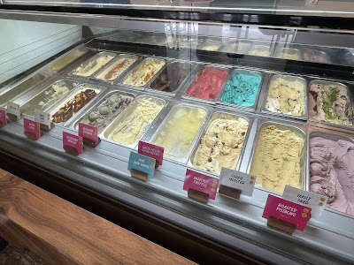 Ice cream display case at Lickers featuring Salted Caramel, Valrhona Chocolate, Rosemary Vanilla, Watermelon Strawberry, Ube Shan Wang, Hazelnut Truffle, Cookie Monster, Yakult Ored, and Roasted Pistachio flavors. — Items: Salted Caramel · Valrhona Chocolate · Rosemary Vanilla · Watermelon Strawberry · Ube Shan Wang · Hazelnut Truffle · Cookie Monster · Yakult Ored · Roasted Pistachio