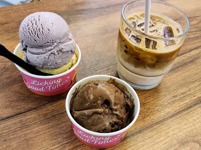 Lickers ice cream shop desserts: lavender ice cream, chocolate ice cream, and iced coffee drink served on wooden table. — Items: Lavender Ice Cream · Chocolate Ice Cream · Iced Coffee Drink