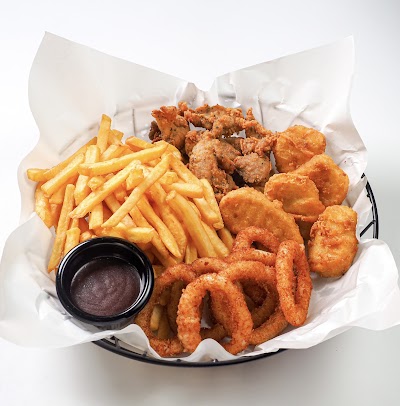 Bradley's Grill seafood and fried chicken combo platter with French fries, onion rings, fried shrimp, and fried chicken served with dipping sauce. — Items: French Fries · Fried Chicken · Fried Shrimp · Onion Rings · Dipping Sauce