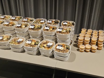 N2 No Nonsense Foods Nanyang Poly meal prep containers with stir-fried rice, vegetables and protein, plus peanut butter cups displayed on table. — Items: Rice Bowl with Vegetables and Protein · Stir-fried Rice Dish · Mixed Vegetable Rice · Peanut Butter Cup or Dessert