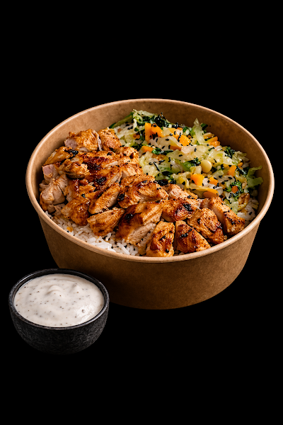 N2 No Nonsense Foods Nanyang Poly teriyaki chicken rice bowl with glazed chicken pieces, white rice, and vegetable fried rice topped with black sesame seeds, served with creamy sauce. — Items: Teriyaki Chicken Rice Bowl · White Rice · Vegetable Fried Rice with Corn, Peas, and Greens · Creamy Sauce