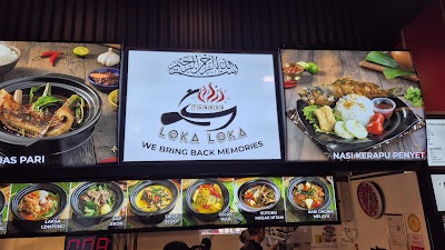 Loka Loka restaurant menu board displaying Southeast Asian dishes including Laksa Lontong, Sop Ekor, Sipot Sedot, Celok Ikan, Sotong Masak Hitam, and Kari Daging Merah with tagline 'We Bring Back Memories' — Items: Ikan Pari (Stingray) · Nasi Kerapu Penyet · Laksa Lontong · Sop Ekor · Sipot Sedot · Celok Ikan · Sotong Masak Hitam · Kari Daging Merah