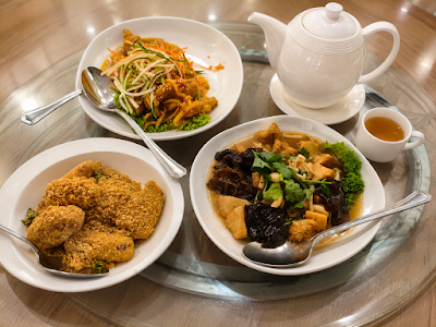 Yes Natural Restaurant table spread featuring fried chicken, stir-fried mushrooms with ginger, black fungus with tofu, and tea service on white porcelain plates. — Items: Fried Chicken · Stir-fried Mushrooms with Ginger · Black Fungus with Tofu · Tea