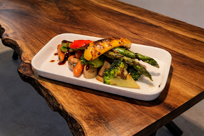 d.o.c Italian Restaurant grilled chicken breast with roasted asparagus, mushrooms, and red bell peppers on a white rectangular plate — Items: Grilled Chicken with Roasted Vegetables · Asparagus · Mushrooms · Red Bell Peppers · Glazed Chicken Breast