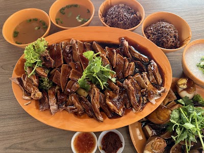 Cheok Kee Duck Rice platter featuring sliced roasted duck with cilantro, served with gravy, braised potatoes, and condiment sauces. — Items: Roasted Duck · Rice · Duck Gravy · Cilantro · Braised Potatoes · Chili Sauce · Soy Sauce