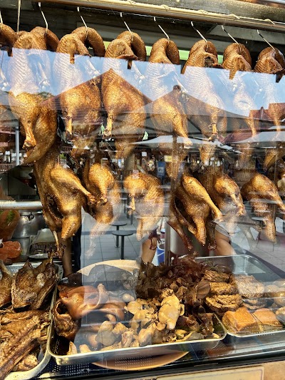 Cheok Kee Duck Rice storefront display featuring roasted duck, duck rice, roasted chicken, duck offal, and braised peanuts hanging and arranged in the window. — Items: Roasted Duck · Duck Rice · Roasted Chicken · Duck Offal · Braised Peanuts