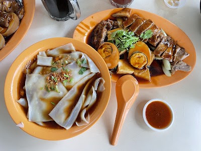 AC Braised Duck and Kway Chap Food Enterprise meal spread featuring kway chap noodles, braised duck with vegetables, and braised pork ribs served on orange plates with sauce. — Items: Kway Chap · Braised Duck · Braised Pork Ribs