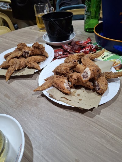 Roger's Kitchen fried chicken wings and pieces served on white plates with beverages including Heineken beer at a dining table. — Items: Fried Chicken Wings · Fried Chicken