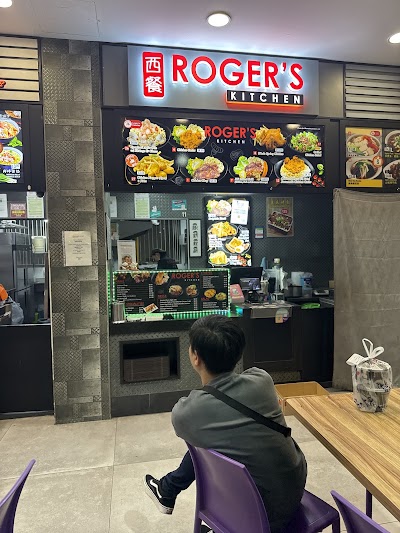 Roger's Kitchen storefront with menu board displaying various Asian dishes including fried rice, chicken, stir-fried vegetables, and noodle dishes with colorful food photography. — Items: Fried Rice · Chicken Dish · Stir-fried Vegetables · Meat Dish with Rice · Egg Fried Rice · Noodle Dish · Asian Cuisine Plates