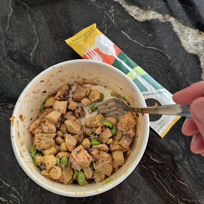 Freshpod SG healthy meal bowl featuring cubed chicken with green peas in a creamy sauce, served with biodegradable cutlery from Gleneagles Hospital Singapore. — Items: Chicken and Peas Bowl