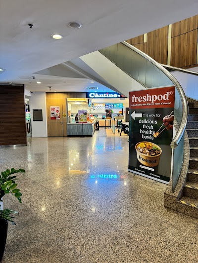 Freshpod restaurant signage at Gleneagles Hospital Singapore advertising delicious fresh healthy bowls with modern food court interior and escalators visible. — Items: Fresh healthy bowls