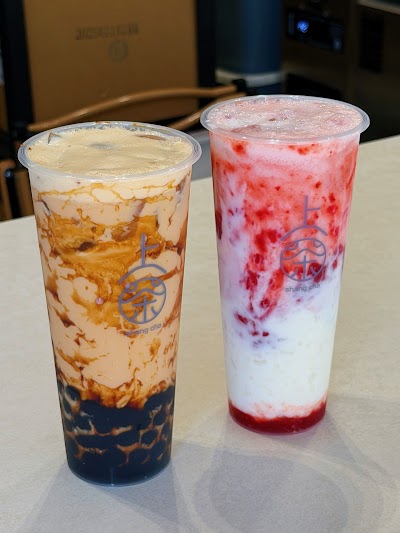 Two bubble tea drinks from Shang Cha: Brown Sugar Boba Milk Tea and Strawberry Milk Tea with tapioca pearls and cream toppings. — Items: Brown Sugar Boba Milk Tea · Strawberry Milk Tea