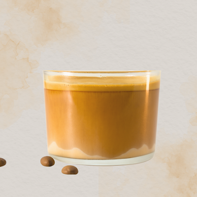 A glass of black kettle coffee with a rich golden-brown color and crema top, garnished with coffee beans on a white surface. — Items: Coffee Beverage