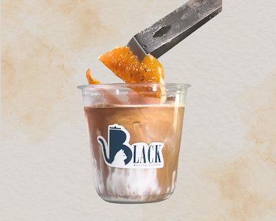 Black Kettle Coffee iced coffee drink with orange peel garnish and chef's knife, showcasing a refreshing beverage presentation. — Items: Iced Coffee with Orange Peel Garnish