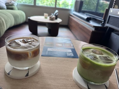 Two refreshing drinks at Black Kettle Coffee: an iced coffee and a matcha latte served over ice in a modern café setting. — Items: Iced Coffee · Matcha Latte