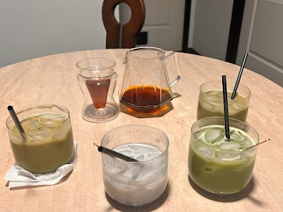 Table spread of cold beverages from Black Kettle Coffee including iced tea, iced coffee, cold brew, iced lemonade, and water with ice served in glasses with straws and a pitcher of concentrate. — Items: Iced Tea · Iced Coffee · Cold Brew Coffee · Iced Lemonade · Water with Ice · Coffee Concentrate